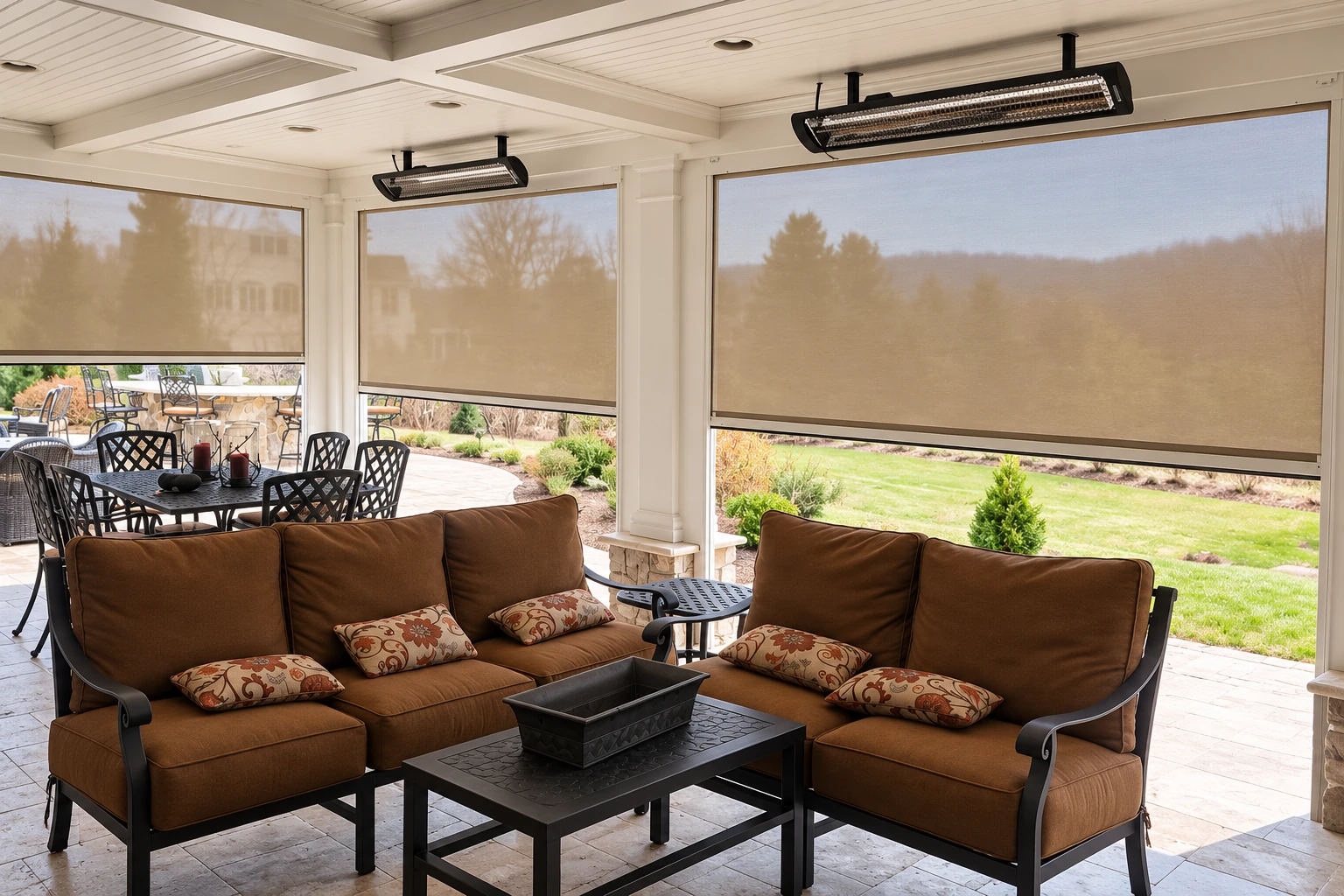 Enclosed patio with lowered mesh shades, brown cushioned seating, a dining set and ceiling-mounted heaters.